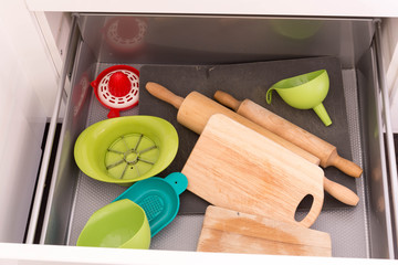 Opened drawer full of kitchenware