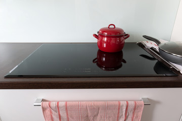 Cooking in red pots on induction hob