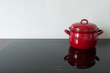 Cooking in red pots on induction hob