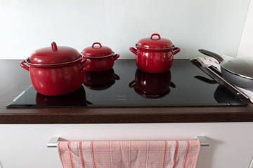 Cooking in red pots on induction hob
