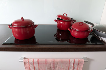 Cooking in red pots on induction hob