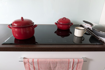 Cooking in red pots on induction hob