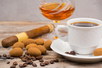 Cigar, brandy, cup coffee espresso with chocolate eggs