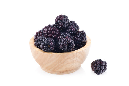 fresh blackberry berry in wood cap on white