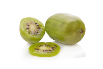 Kiwi berries and a cut one on a white background