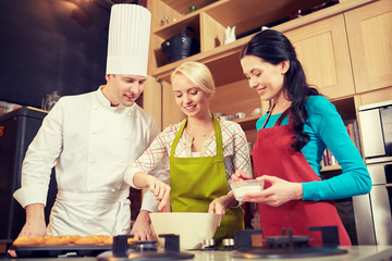 happy women and chef cook baking in kitchen