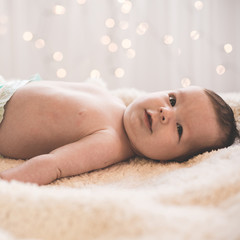 Happy newborn lying on blanket