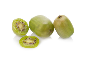 Kiwi berries and a cut one on a white background