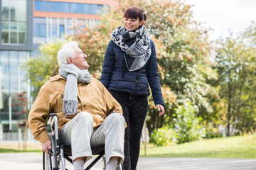 Young woman helping disabled relative