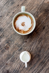  cappuccino coffee cup with mini jar of syrup and wooden spoon a