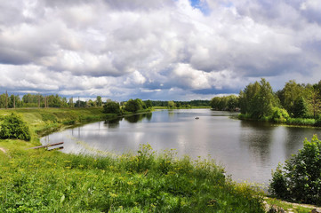 Fototapeta na wymiar Landscape with lake reflection clouds Latvia, Jugla