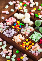 Mix of candies and sweets in wooden box