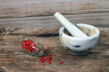 Marble mortar and pestle on old wooden table. 