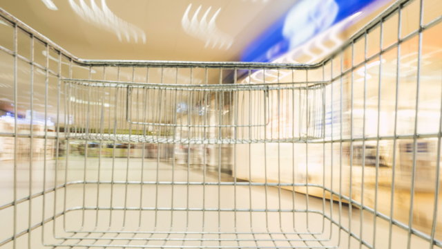 Time-lapse shot of a shopping cart riding through an unrecognizable shopping mall
