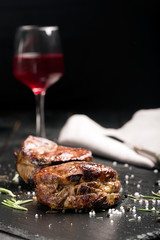Grilled steak meat (mignon) on the dark surface