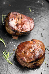 Grilled steak meat (mignon) on the dark surface