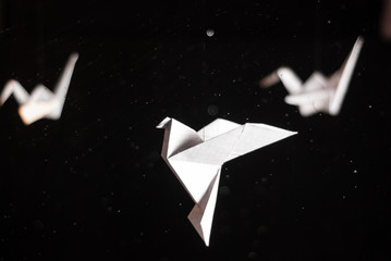 Origami crane on dark background