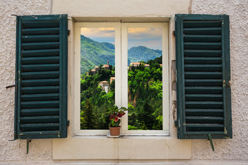 Fototapeta premium Window in an old house decorated with flower