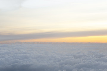 Fototapeta na wymiar High above the clouds with beautiful sunset light