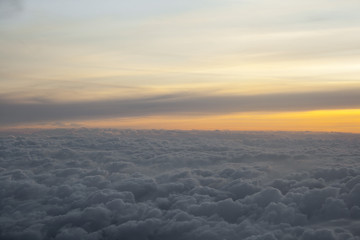 Fototapeta na wymiar High above the clouds with beautiful sunset light