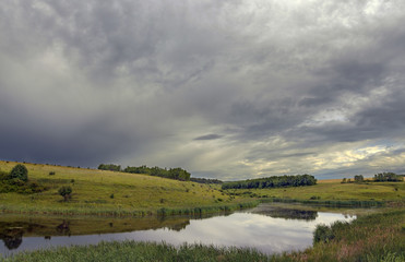 Cloudy countryside landscape with river