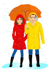 happy couple in raincoats standing with umbrella