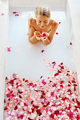 Obraz na płótnie Canvas Woman Body Care. Spa Bath With Rose Petals. Close-up Of Sexy Blonde Female In Bikini Taking Flower Bath In Resort Day Spa Centre. Beauty Treatment, Aroma Therapy. Skin Care. Healthy Lifestyle Concept