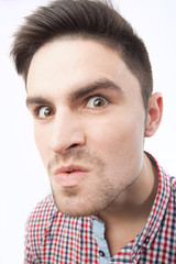 Obraz premium Funny crazy evil insane grotesque men’s face isolated on white background