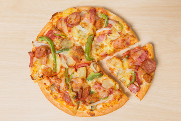 Pizza with sliced vegetables on wood