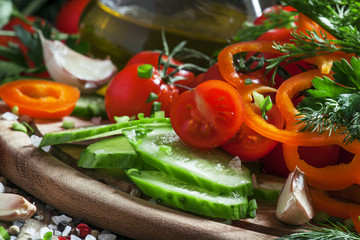 Obraz na płótnie Canvas Fresh vegetables, chopped for salad, garlic, spices, herbs and o