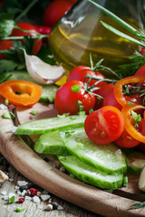 Fresh vegetables, chopped for salad, garlic, spices, herbs and o
