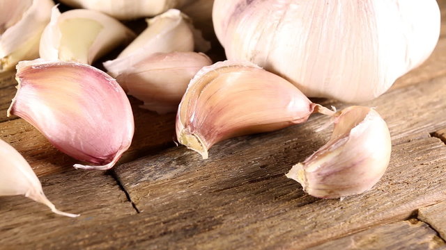 Organic garlic on wooden background. Macro shot.