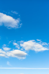 blue sky with clouds and horizontal airplane trace