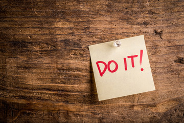 do it! - motivation paper note on wood noticeboard - left text space