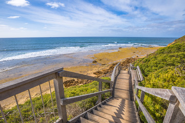 Fototapeta na wymiar Walkway to the legendary Bells Beach - the beach of the cult film Point Break, near Torquay, gateway to the Surf Coast of Victoria, Australia, where starts the tourist and Great Ocean road.