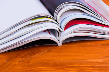 Stack of magazines on a wooden background