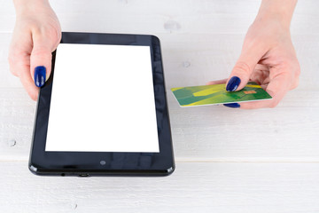 Woman enters credit card details a tablet PC