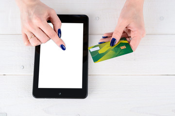 Woman enters credit card details a tablet PC