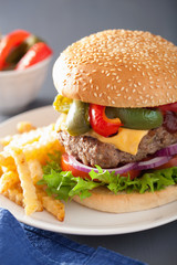 homemade cheese burger with peppers tomato onion