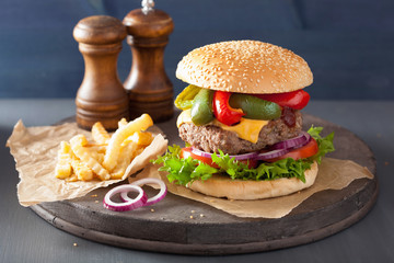 homemade cheese burger with peppers tomato onion