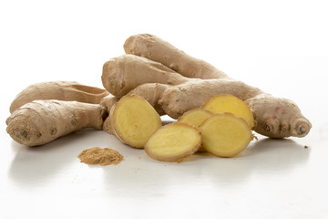 Ginger root and slices on white background