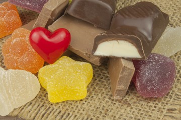 Jelly candy and chocolate on the tablecloth. Sweets for children.
