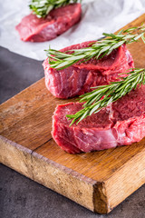 Steak. Raw beef steak. Fresh raw Sirloin beef steak sliced or whole ready for BBQ or grill. Herb - Rosemary decoration.