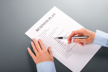 Woman's hand with business plan.