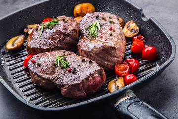 Grill beef steak. Portions thick beef juicy sirloin steaks on grill teflon pan or old wooden board.