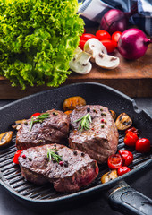 Grill beef steak. Portions thick beef juicy sirloin steaks on grill teflon pan or old wooden board.