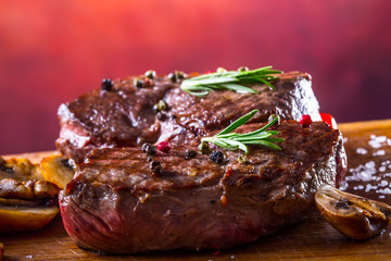 Grill beef steak. Portions thick beef juicy sirloin steaks on grill teflon pan or old wooden board.