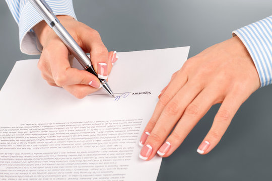 Woman signing rent contract. 