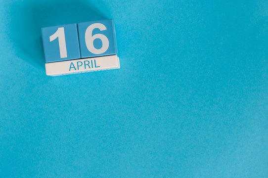 April 16th. Image of april 16 wooden color calendar on white background.  End month. Spring day, empty space for text