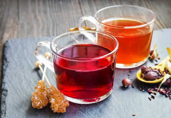 Red berries tea in transparent cups with dried flowers and fruit